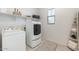 Bright laundry room featuring modern washer/dryer, shelves, and stylish decorative accents at 9856 E Palladium Dr, Mesa, AZ 85212