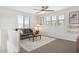 Comfortable loft space with a cozy couch, soft rug, and natural light from three windows at 9856 E Palladium Dr, Mesa, AZ 85212
