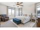 Tranquil main bedroom features a large bed, a blue bench, and two bedside tables with lamps at 9856 E Palladium Dr, Mesa, AZ 85212