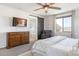This main bedroom features a TV, dresser, and sliding barn door to the bathroom at 9856 E Palladium Dr, Mesa, AZ 85212