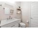 Charming powder room with a modern vanity, floating shelves, and stylish decor at 9856 E Palladium Dr, Mesa, AZ 85212