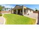 Expansive backyard featuring a covered patio and well-maintained green lawn at 1022 N Kirby St, Gilbert, AZ 85234