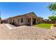 A spacious backyard features a covered patio and a mix of gravel and grassy areas for outdoor enjoyment at 1022 N Kirby St, Gilbert, AZ 85234