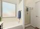 Clean bathroom with a tub, glass-door shower, and plenty of natural light at 1022 N Kirby St, Gilbert, AZ 85234
