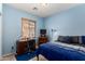 Blue bedroom featuring window, desk, and chair at 1022 N Kirby St, Gilbert, AZ 85234