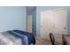 Light blue bedroom with closet, chair, and neutral carpet at 1022 N Kirby St, Gilbert, AZ 85234