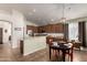 Eat-in kitchen featuring wood cabinets, granite counters, and a pendant light fixture at 1022 N Kirby St, Gilbert, AZ 85234