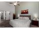 Spacious main bedroom with a ceiling fan, neutral colors, and an ensuite bathroom entrance at 1022 N Kirby St, Gilbert, AZ 85234