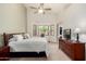 Bright main bedroom with a large window, ceiling fan, and neutral carpeting at 1022 N Kirby St, Gilbert, AZ 85234