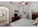 Bright main bedroom featuring a ceiling fan, ensuite bathroom entrance, and adjoining doors at 1022 N Kirby St, Gilbert, AZ 85234