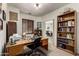Well-lit office space with a built-in bookshelf and a view to the dining room at 1022 N Kirby St, Gilbert, AZ 85234