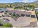 An aerial view of a single-Gathering home with a circular driveway, desert landscaping, and a mountain backdrop at 10448 E Glencove St, Mesa, AZ 85207