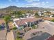 Aerial view of property with mountain views, pool and backyard entertainment spaces at 10448 E Glencove St, Mesa, AZ 85207
