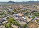 Aerial view of a community, highlighting the single-Gathering home with a pool, circular driveway and desert landscaping at 10448 E Glencove St, Mesa, AZ 85207