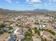 A neighborhood featuring homes with pools, desert landscaping, and mountain views in an aerial view at 10448 E Glencove St, Mesa, AZ 85207