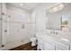 Elegant bathroom features a walk-in shower, white vanity, and contemporary lighting at 10448 E Glencove St, Mesa, AZ 85207