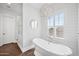 Elegant bathroom featuring a freestanding tub with stylish fixtures and a modern chandelier at 10448 E Glencove St, Mesa, AZ 85207