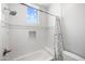 Bright bathroom with white subway tile shower over tub, shower curtain, small window, and built-in niche at 10448 E Glencove St, Mesa, AZ 85207