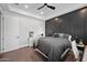 Modern bedroom features a tray ceiling, black accent wall, one window, and carpeted floors at 10448 E Glencove St, Mesa, AZ 85207