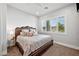 Cozy bedroom showcasing a decorative headboard, neutral color palette, and shuttered windows at 10448 E Glencove St, Mesa, AZ 85207