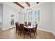 Inviting dining room featuring modern lighting, shuttered windows, and backyard views at 10448 E Glencove St, Mesa, AZ 85207