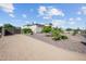 Landscaped front yard with desert plants and secure gated entrance at 10448 E Glencove St, Mesa, AZ 85207