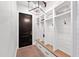 Hallway mudroom with black door, shiplap walls, light fixture, storage lockers with wooden bench, and drawers at 10448 E Glencove St, Mesa, AZ 85207