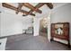 Bright office with exposed beams, an arm chair, and view into the foyer at 10448 E Glencove St, Mesa, AZ 85207