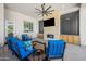 Covered patio with stone fireplace, ceiling fan, and outdoor seating at 10448 E Glencove St, Mesa, AZ 85207