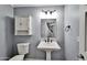 Charming powder bathroom features a pedestal sink, decorative mirror and cabinet at 10997 E Altadena Ave, Scottsdale, AZ 85259