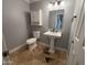 Cozy powder bathroom features a pedestal sink and patterned tile floor at 10997 E Altadena Ave, Scottsdale, AZ 85259