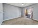 Bedroom featuring modern ceiling fan, neutral paint, sliding patio door, and pink curtains at 10997 E Altadena Ave, Scottsdale, AZ 85259