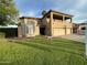 Charming two-story home featuring a well-manicured lawn and a three-car garage at 10997 E Altadena Ave, Scottsdale, AZ 85259