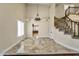 Entryway with marble floors leading to a living space with hardwood floors and staircase at 10997 E Altadena Ave, Scottsdale, AZ 85259