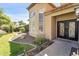 Close up of home's front door with wrought iron design and manicured landscaping at 10997 E Altadena Ave, Scottsdale, AZ 85259