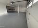 Well-lit garage featuring epoxy flooring, providing a clean and functional space at 10997 E Altadena Ave, Scottsdale, AZ 85259