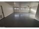 Spacious garage with epoxy flooring and ample room for parking and storage at 10997 E Altadena Ave, Scottsdale, AZ 85259