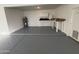 Organized garage with epoxy flooring and built-in features at 10997 E Altadena Ave, Scottsdale, AZ 85259