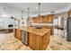 Gourmet kitchen boasts a large island, wine fridge, granite counters, and custom cabinetry at 10997 E Altadena Ave, Scottsdale, AZ 85259