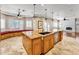 Spacious kitchen features a large island with seating, granite countertops and stainless steel appliances at 10997 E Altadena Ave, Scottsdale, AZ 85259