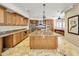 Large kitchen featuring a center island, granite countertops, and wood cabinets at 10997 E Altadena Ave, Scottsdale, AZ 85259