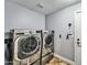 Functional laundry room with modern washer and dryer units, offering convenience and efficiency at 10997 E Altadena Ave, Scottsdale, AZ 85259