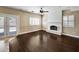 Bright living room features a whitewashed brick fireplace and wood floors at 10997 E Altadena Ave, Scottsdale, AZ 85259