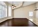 Spacious living room with hardwood floors, large windows, and vaulted ceilings at 10997 E Altadena Ave, Scottsdale, AZ 85259