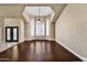 Bright living room with hardwood floors, recessed lighting, and tall, shuttered windows at 10997 E Altadena Ave, Scottsdale, AZ 85259
