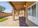 Charming covered patio with brick pavers and serene views of the pool and backyard at 10997 E Altadena Ave, Scottsdale, AZ 85259