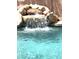 Beautiful pool featuring a rock waterfall for a relaxing backyard oasis at 10997 E Altadena Ave, Scottsdale, AZ 85259