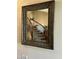 Elegant staircase with wooden banister and carpeted steps, reflected in an ornate mirror at 10997 E Altadena Ave, Scottsdale, AZ 85259