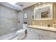 Charming bathroom featuring granite countertop, a framed mirror, and a walk-in tiled shower at 11144 N 109Th Way, Scottsdale, AZ 85259