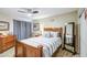 Comfortable bedroom with wood furnishings, ceiling fan, neutral decor, and ample natural light at 11144 N 109Th Way, Scottsdale, AZ 85259